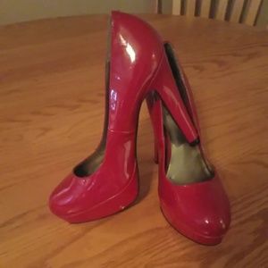 Red faux leather pumps